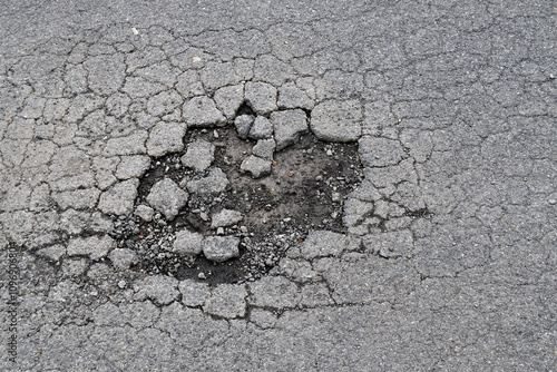 large hole on asphalt road, highway with dirt mud pothole and fracture, damage textured tarmac road, transportation background
