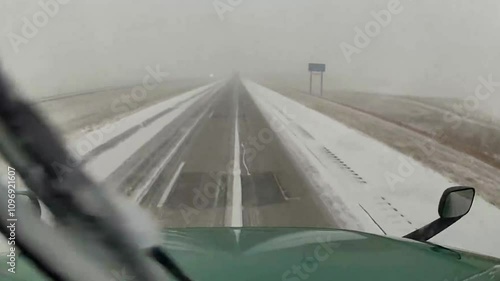 Terrifying Jackknife Truck Crash on Black Ice During Snowy Winter Weather. Captured on snowy highway, truck jackknifing on black ice, highlighting the dangers of winter driving in treacherous weather