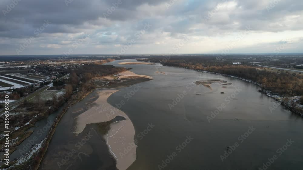 Panorama of the Vistula River near Warsaw in Poland on the first day of snowfall, a sandy island, snow-covered fields Panorama of the Vistula River near Warsaw in Poland on the first day of snowfall, a sandy island, snow-covered fields