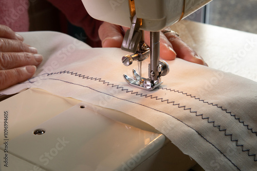 A hobbyist using an electric  sewing machine