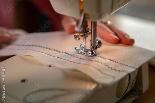 A hobbyist using an electric  sewing machine