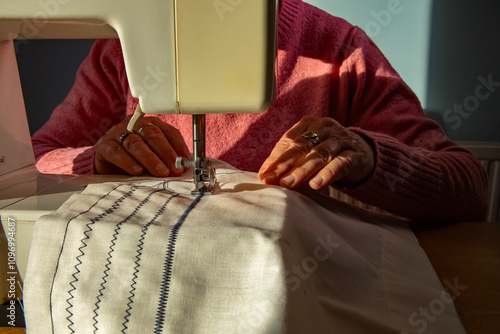 A hobbyist using an electric  sewing machine