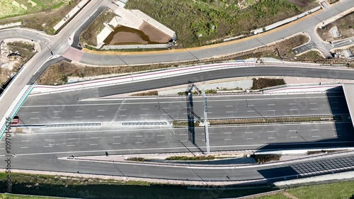 Krakow, Poland. Wegrzce highway interchange under construction on S53, part of motorway ring way around Cracow. Traffic circle with a hole inside, viaducts, tunnels and ramps. September 2024. Aerial