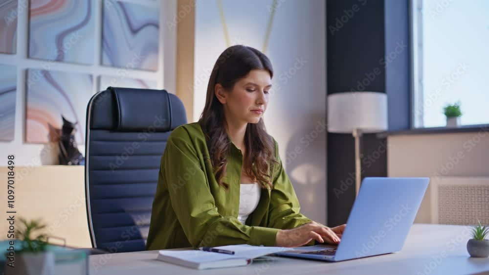 Frustrated woman making notes in notebook reading bad news at laptop screen. Frustrated woman making notes in notebook reading bad news at laptop screen.