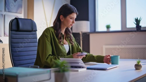 Office manager start work day sit down modern workplace with coffee cup closeup.
