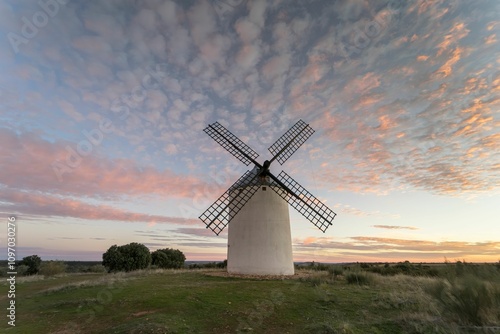 Windmill at sunset in a place of the spot called Vinuelas with pink sky (Guadalajara) Spain photo