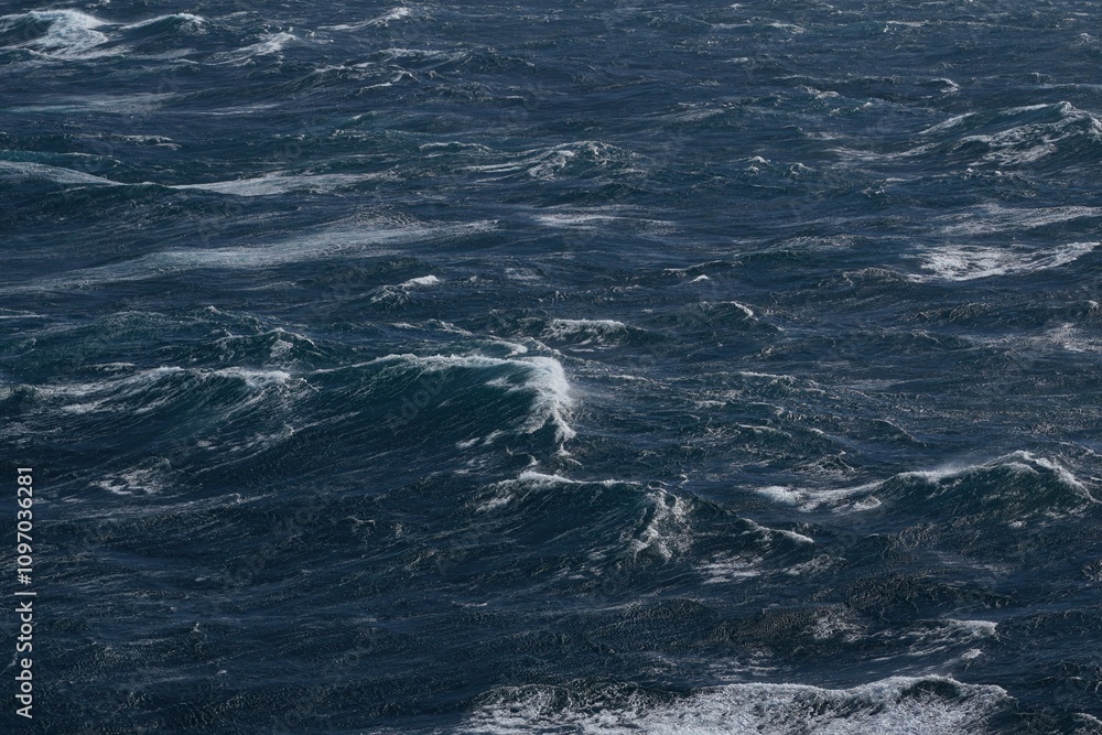 Dark ocean waves with white foam creating dynamic seascape. turbulent water reflects sense of power and movement, showcasing nature raw beauty Dark ocean waves with white foam creating dynamic seascape. turbulent water reflects sense of power and movement, showcasing nature raw beauty