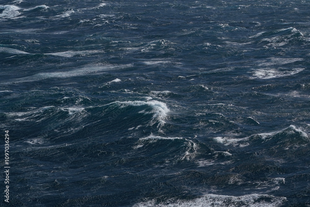 Dark ocean waves with white foam creating dynamic seascape. turbulent water reflects moody atmosphere, showcasing nature power and beauty Dark ocean waves with white foam creating dynamic seascape. turbulent water reflects moody atmosphere, showcasing nature power and beauty