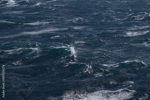 Obraz na płótnie image captures turbulent ocean surface with dark, choppy waves creating dramatic and powerful scene