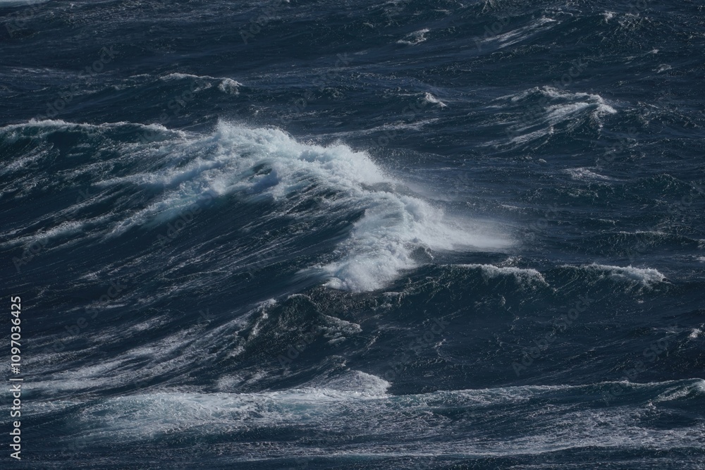 Powerful ocean waves crashing in stormy sea, creating dramatic scene of nature force Powerful ocean waves crashing in stormy sea, creating dramatic scene of nature force