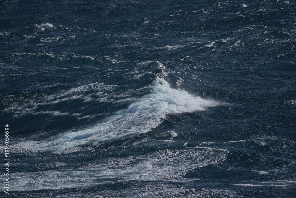 image captures dynamic movement of ocean waves, showcasing deep blue water and frothy white crests. scene evokes sense of power and tranquility in nature image captures dynamic movement of ocean waves, showcasing deep blue water and frothy white crests. scene evokes sense of power and tranquility in nature