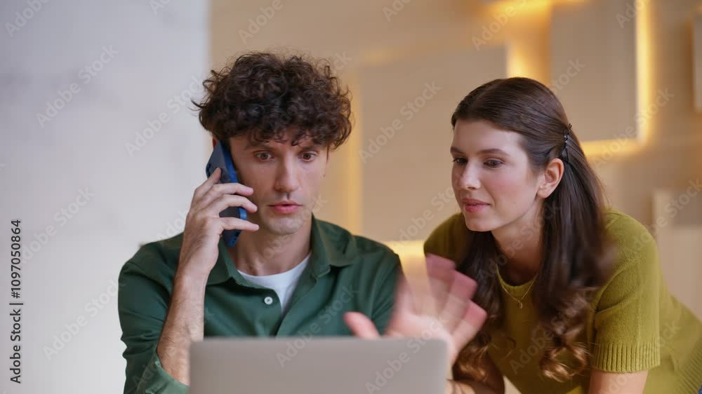 Excited colleagues negotiating cellphone reacting emotionally in office closeup. Excited colleagues negotiating cellphone reacting emotionally in office closeup.