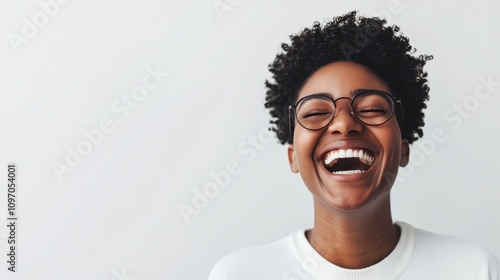 Joyful laughter expressed by young woman in studio portrait photography indoor setting wellness concept