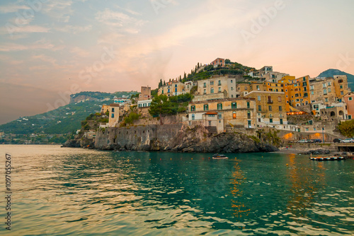 Obraz na płótnie This image showcases Minori on the Amalfi Coast, with its charming seaside houses, tranquil beach, and lush green hills, bathed in the warm Mediterranean light. w salonie