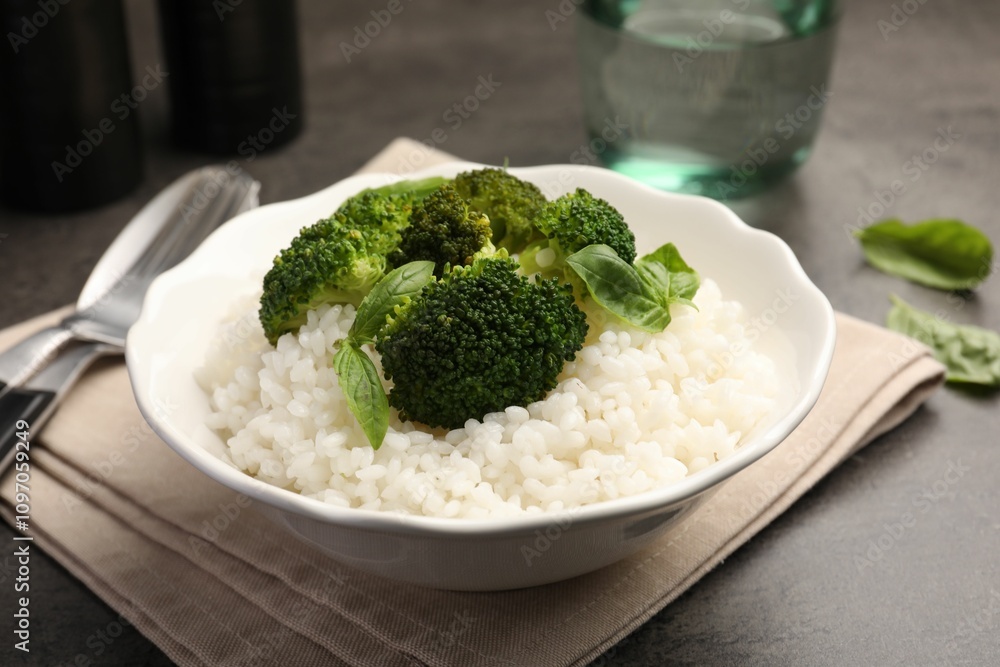 Tasty rice with broccoli served on grey table, closeup Tasty rice with broccoli served on grey table, closeup