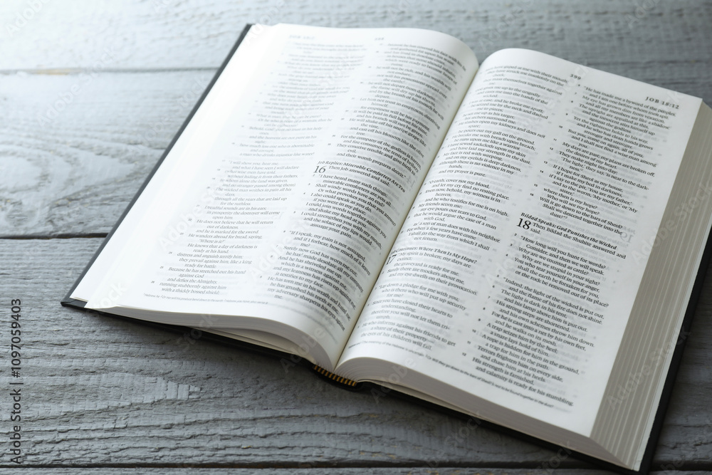 Open Holy Bible in English language on wooden table Open Holy Bible in English language on wooden table