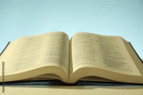 Open Holy Bible in English language on white table, closeup