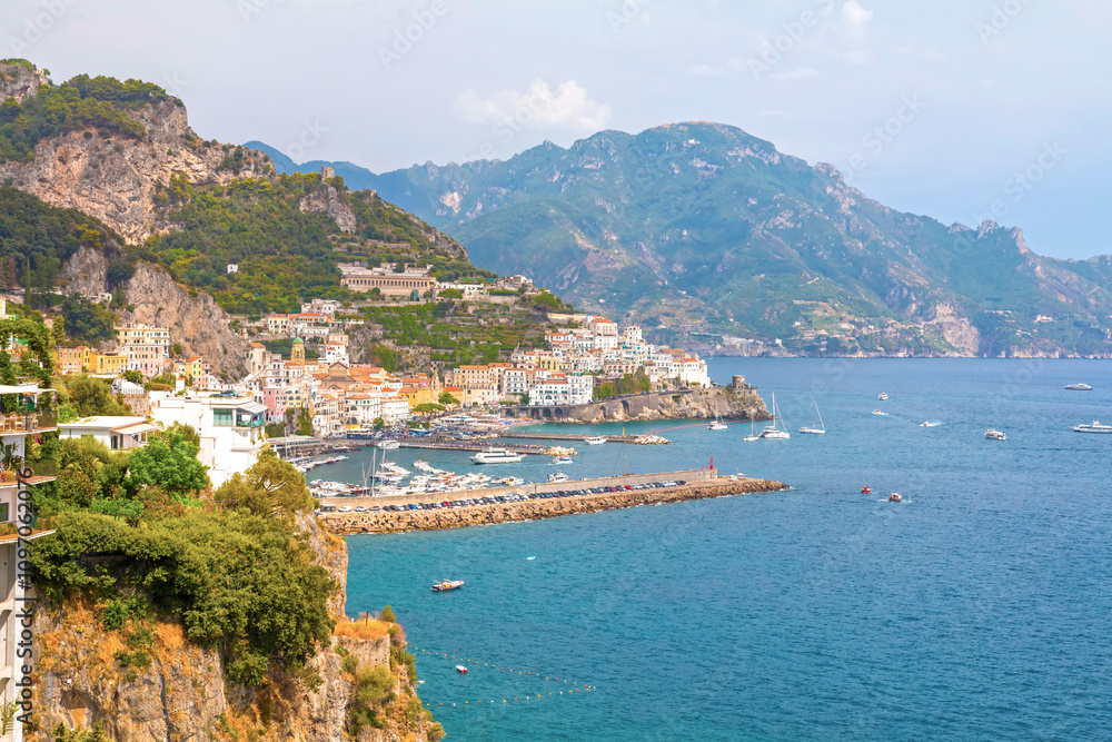 The photo captures the stunning Amalfi Coast from a cruise ship deck, showcasing dramatic cliffs, charming villages, and lush landscapes against the turquoise sea and vibrant blue sky. The photo captures the stunning Amalfi Coast from a cruise ship deck, showcasing dramatic cliffs, charming villages, and lush landscapes against the turquoise sea and vibrant blue sky.