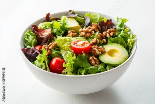 Bowl of fresh green salad with avocado slices, cherry tomatoes, mixed greens, and almonds