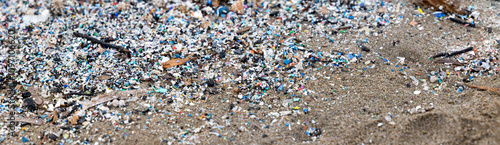 microplastics on the beach, an example of pollution, panorama banner