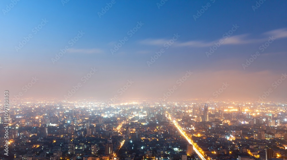 Fototapeta premium Beautiful urban night cityscape with glowing lights and illuminated streets stretching to horizon. Aerial panoramic view of modern metropolis under evening sky. City lights banner with copy space