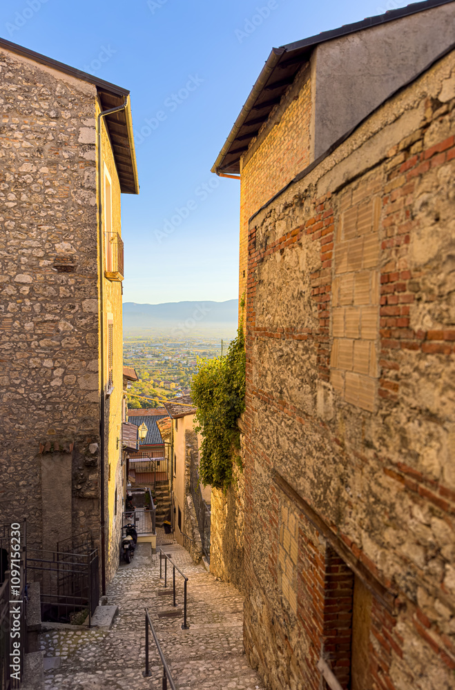 A stone staircase leads up a narrow street in an Italian village A stone staircase leads up a narrow street in an Italian village