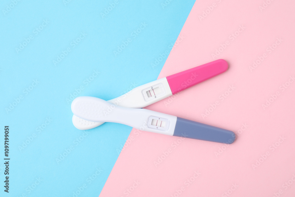 Two pregnancy tests on color background, top view Two pregnancy tests on color background, top view