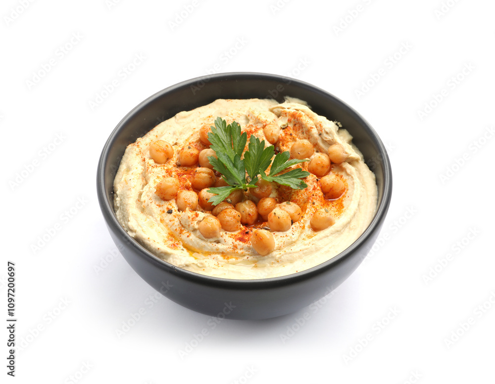 Delicious hummus with parsley, paprika and chickpeas in bowl isolated on white Delicious hummus with parsley, paprika and chickpeas in bowl isolated on white