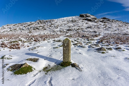 Snow-covered rocks in Dartmoor National Park during winter in the UK photo