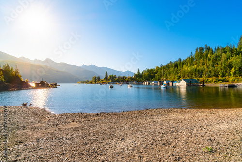 Morning sun on the shipyards, marina, beach and dock on Kootenay Lake in Kaslo Bay, in the rural small village of Kaslo, British Columbia, Canada.	