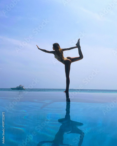28.02.2022 Maldives: Beautiful slender woman in a swimsuit practicing yoga, Maldives, beautiful background, clean water, pool, sea and ocean