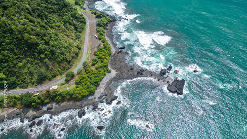 Photos Aerial shot of the coastline with turquoise sea and waves on a sunny day at Jaco