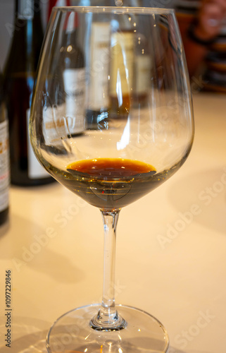 Tasting of sweet Bordeaux white wine in Sauternes, left bank of Gironde Estuary, France. Glasses of white sweet French wine served in restaurant photo