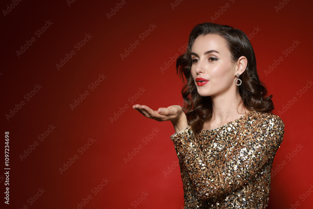 Woman with perfect makeup sending air kiss on red background. Space for text Woman with perfect makeup sending air kiss on red background. Space for text