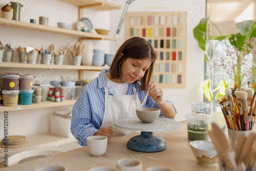 A talented Pottery Artist is passionately Creating oneofakind Unique Ceramics in Their Studio photo