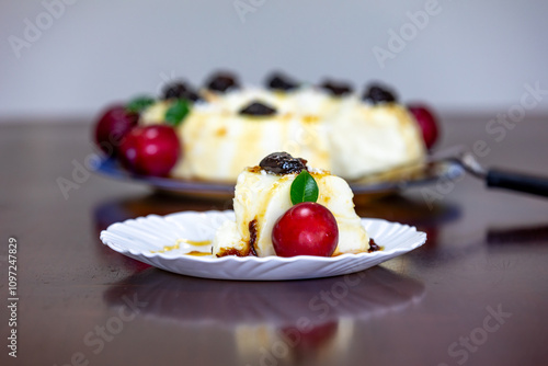 Traditional Brazilian coconut flan dessert known as manjar branco, manjar de coco and manjar dos deuses. Served with plum syrup. photo