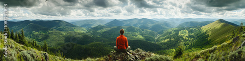 A lone hiker gazing out at the endless, verdant landscape of Oregon's mountains.