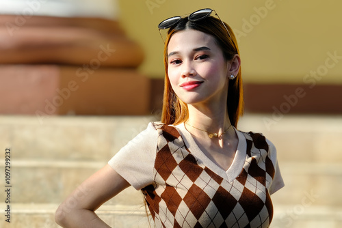 Portrait, head shot, smiling face of a young woman looking at the camera