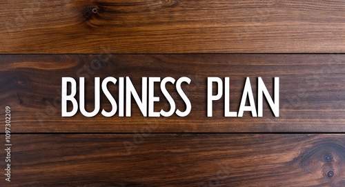 business plan lettering on card with wooden background