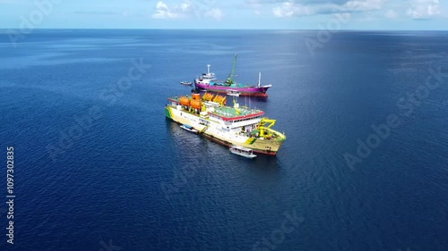 Drone shot of a big ship in the calm ocean on a bright sunny day.