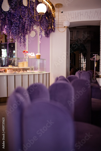 Interior of a cafe in purple colour with velvet purple furniture photo