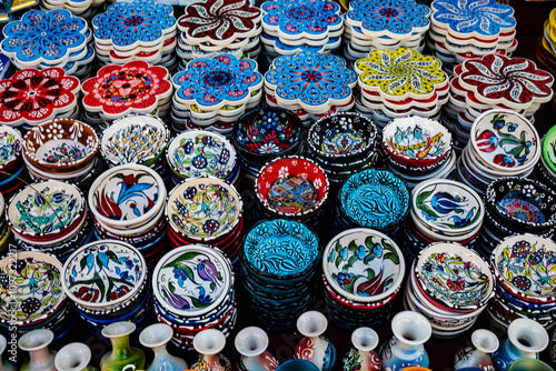 A vibrant display of Turkish ceramics, showcasing a variety of bowls, plates, and coasters, each adorned with intricate patterns and vibrant colors