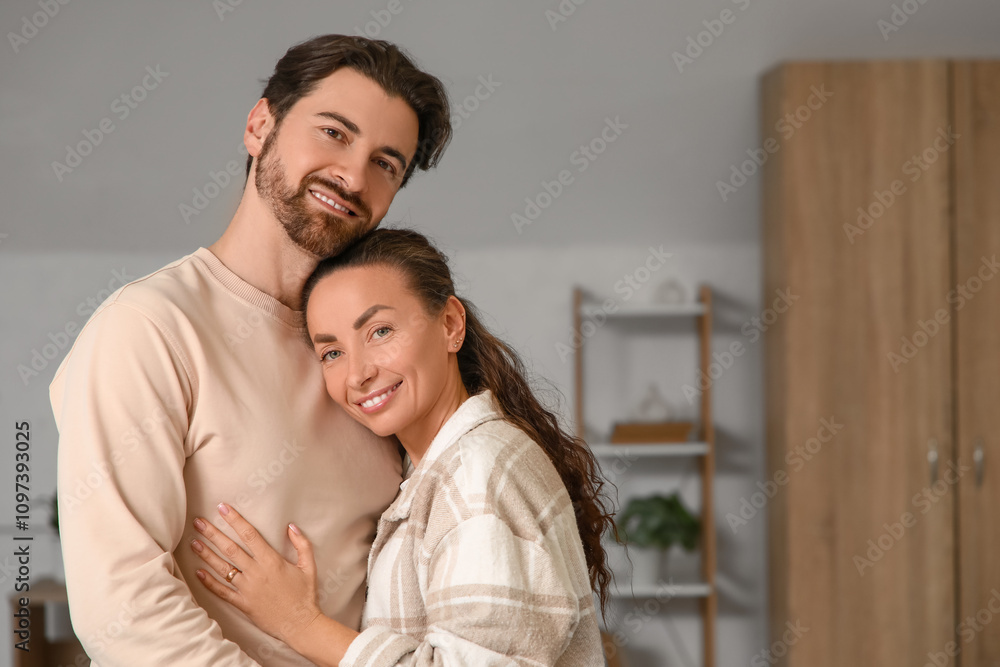 Fototapeta premium Happy married couple hugging at home