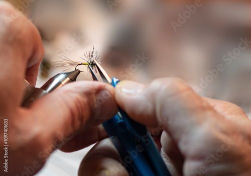 close up of a hands making a fishing fly