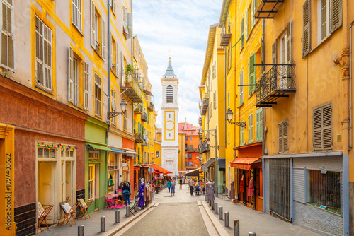 Fototapeta Naklejka Na Ścianę i Meble -  View of the campanile bell tower of the Nice Cathedral at Place Rossetti as tourists enjoy the narrow streets in the colorful Vieux Ville old town of Nice, France.