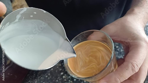 Coffee shop barista making latte art, home barista pouring cappuccino, morning coffee with milk, 
professional coffee art. 
