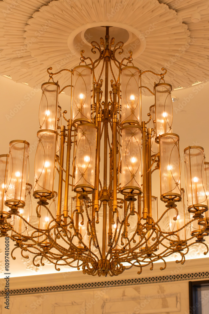 a chandelier that is on a wall with a large chandelier in it.