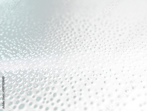 Close-up of water droplets on a dark surface.