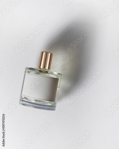 Perfume on white background with beautiful shadow, top view. Caustic, minimalism