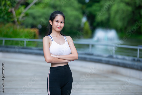 Portrait of fit woman sport wear pose arm cross looking to camera. Beautiful asian female strong activewear healthy body.